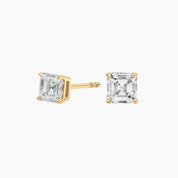 Asscher-cut moissanite stud earrings in yellow gold vermeil, front and side views.