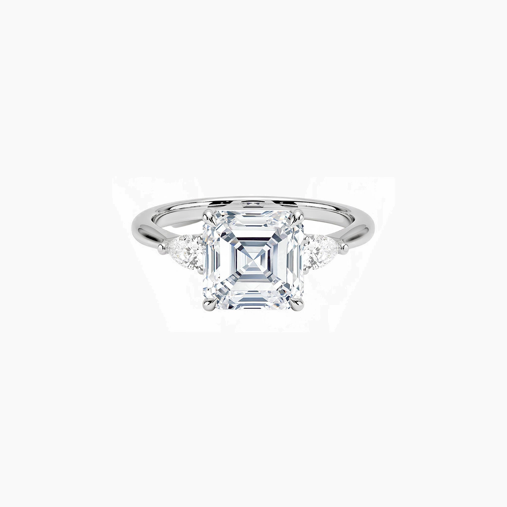 Asscher-cut moissanite three-stone ring in white gold vermeil, front view.
