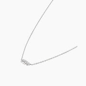 Baguette-cut and round-cut moissanite pendant necklace in white gold vermeil, side view.