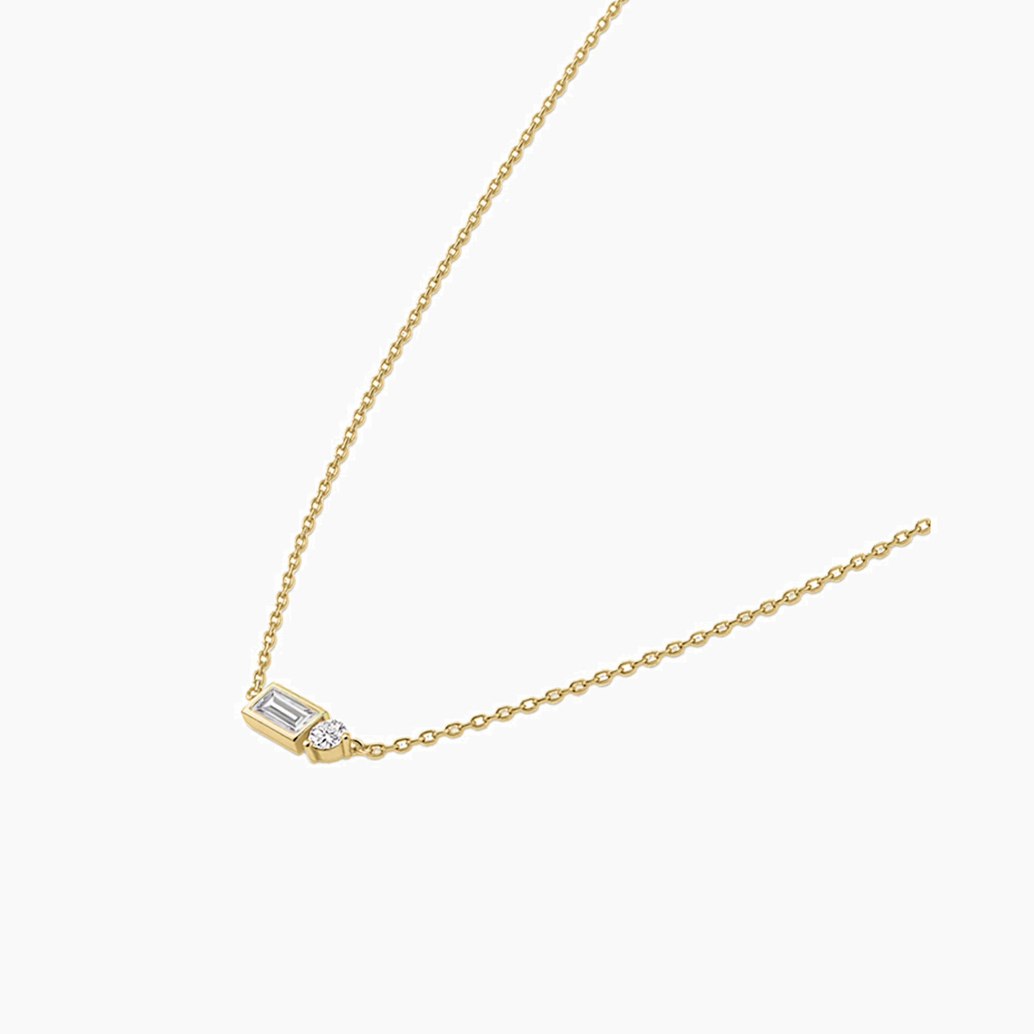 Baguette-cut and round-cut moissanite pendant necklace in yellow gold vermeil, side view.
