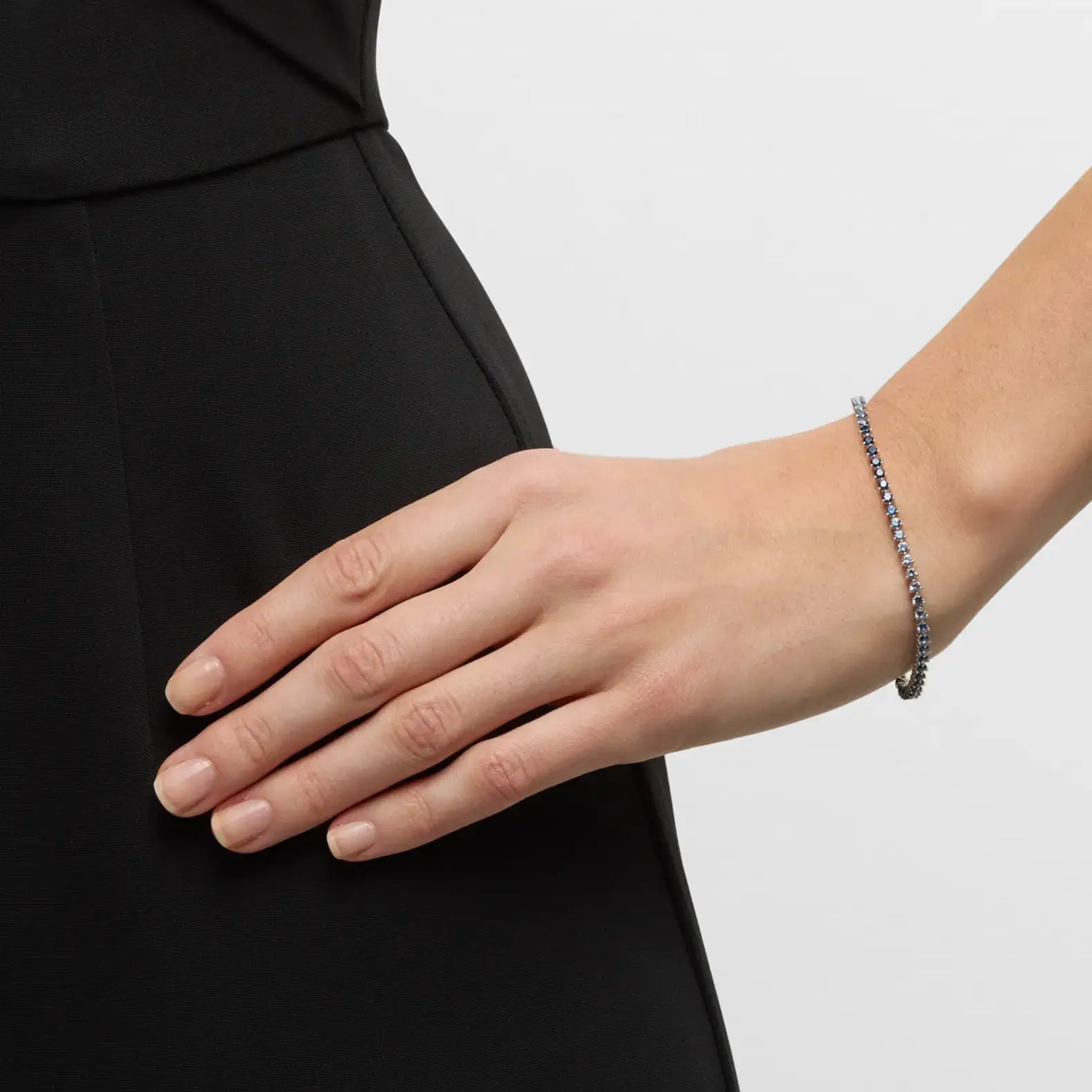 Blue ombré moissanite tennis bracelet worn on the wrist.