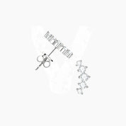 Curved moissanite stud earrings in white gold vermeil, angled view.