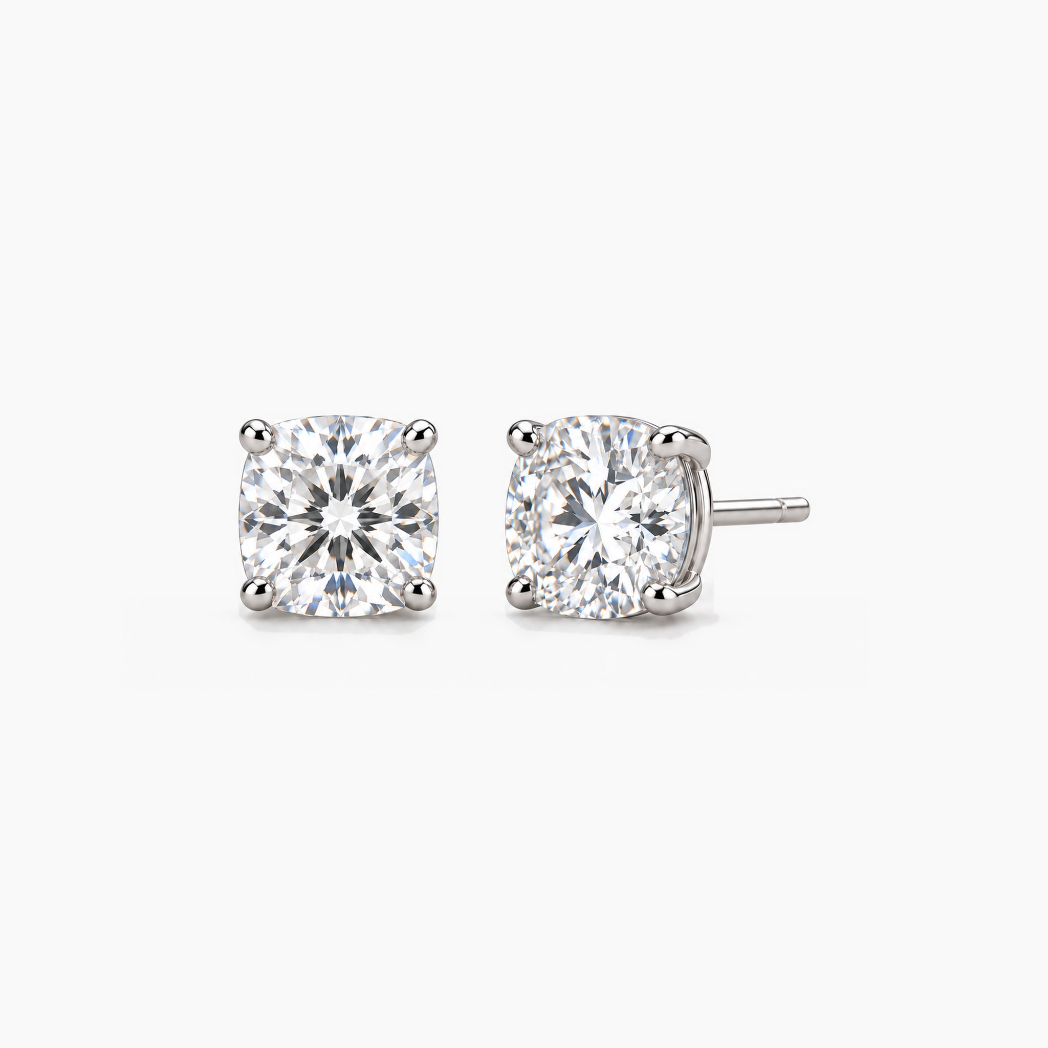 Cushion-cut lab-grown diamond stud earrings in 14k white gold, front and three-quarter views.