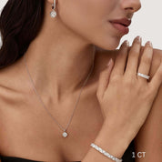 Cushion-cut moissanite bezel pendant necklace worn at the neckline.