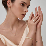 Cushion-cut moissanite bezel pendant necklace worn at the neckline.