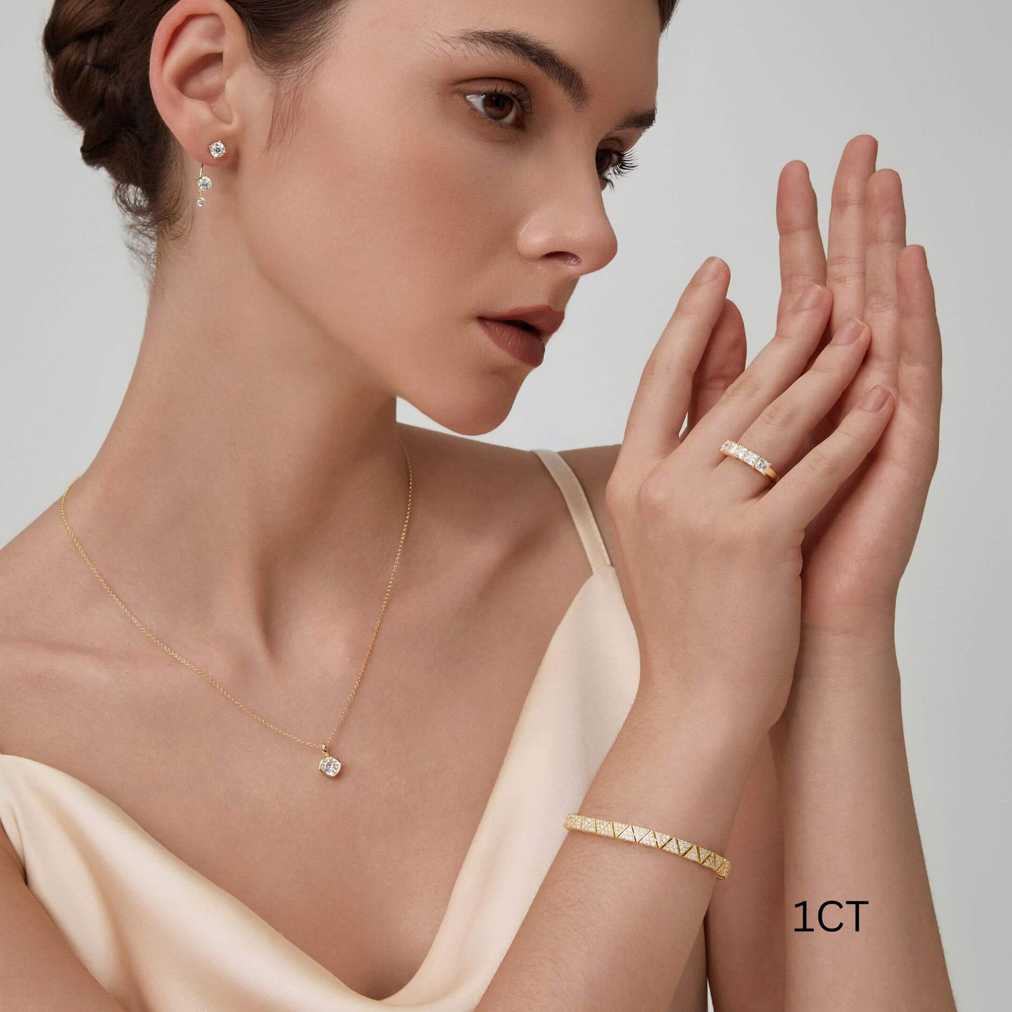 Cushion-cut moissanite bezel pendant necklace worn at the neckline.