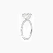 Cushion-cut moissanite hidden halo ring with pavé band in white gold vermeil, side view.