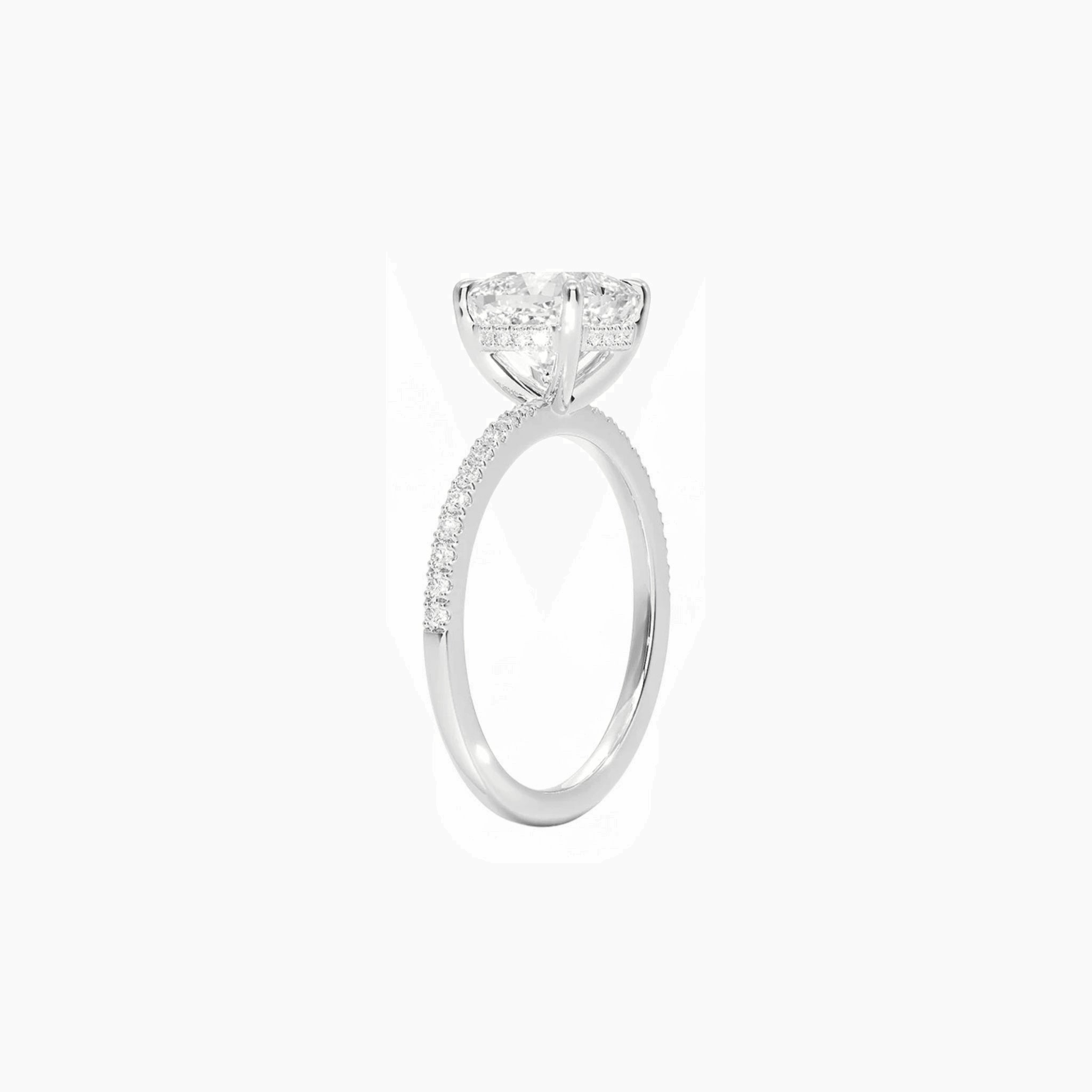 Cushion-cut moissanite hidden halo ring with pavé band in white gold vermeil, side view.