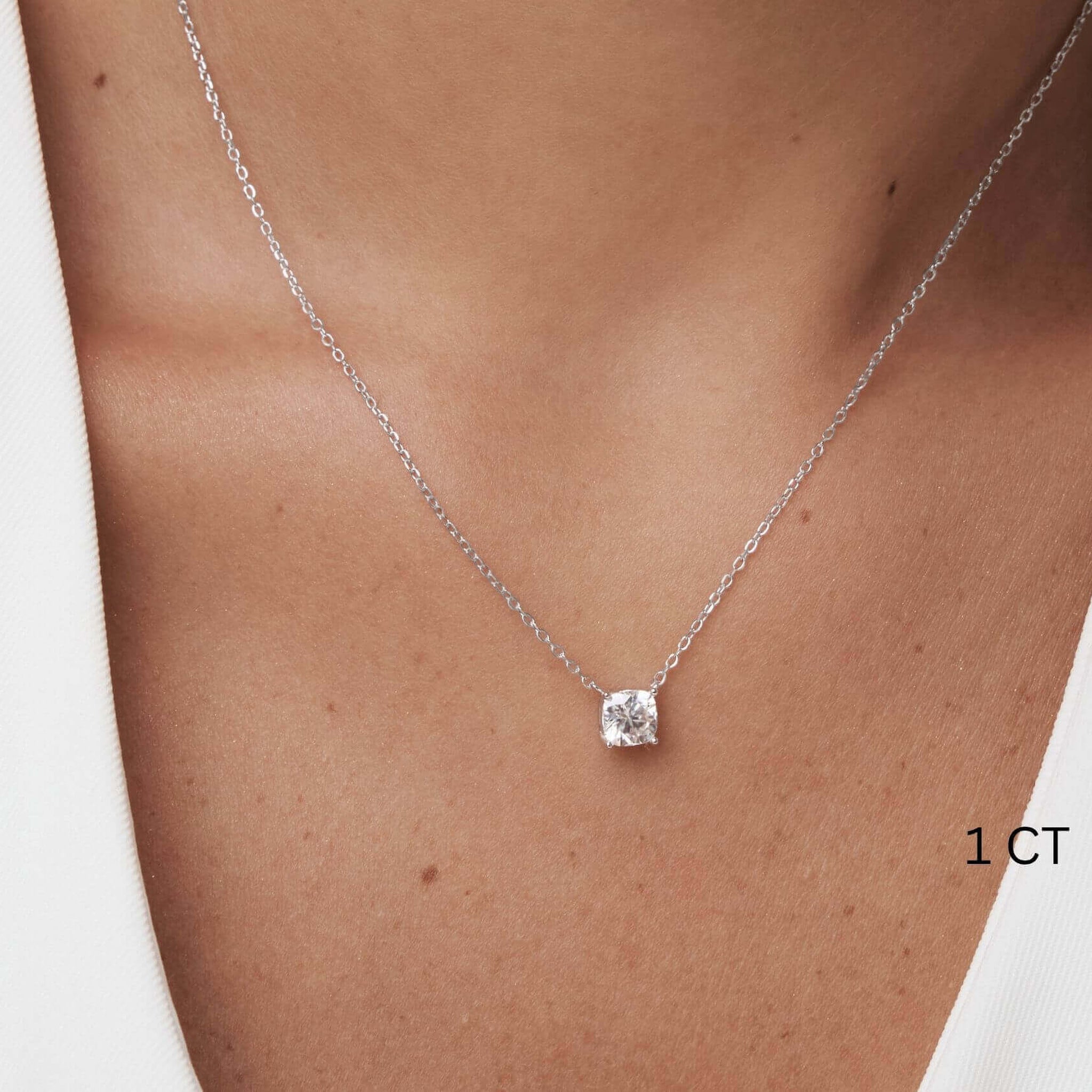 Cushion-cut moissanite pendant necklace worn at the neckline.