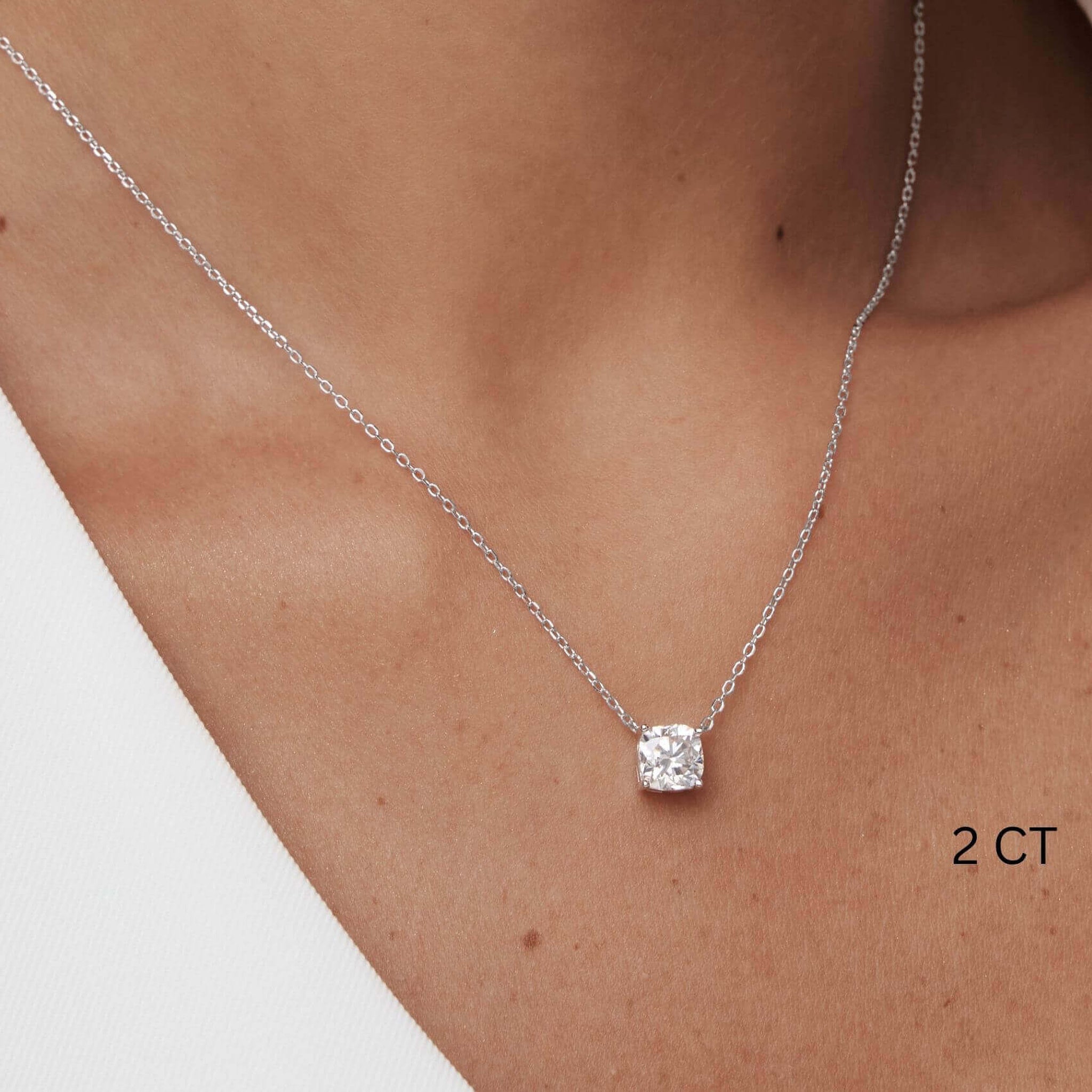 Cushion-cut moissanite pendant necklace worn at the neckline.
