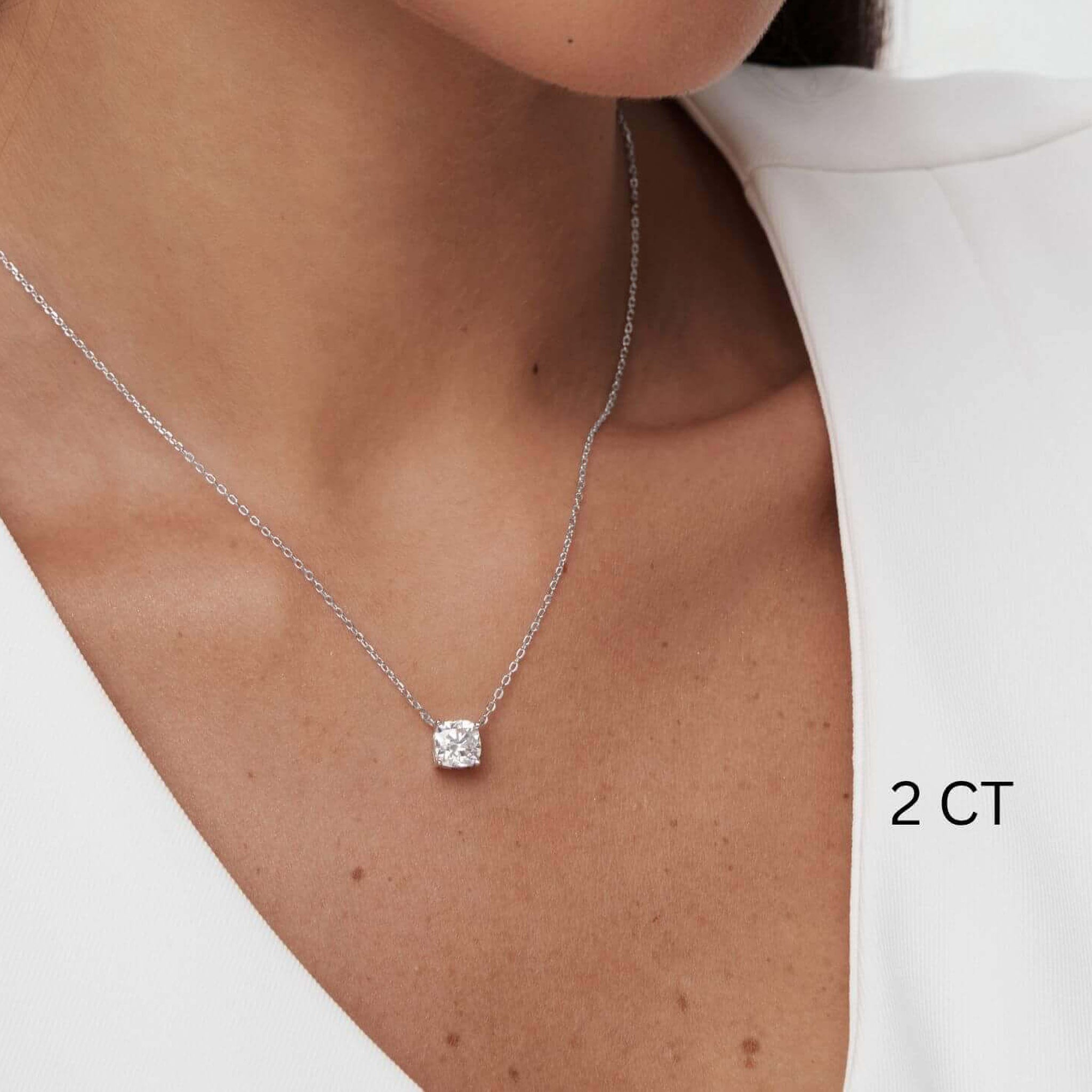 Cushion-cut moissanite pendant necklace worn at the neckline.