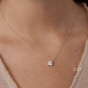 Cushion-cut moissanite pendant necklace worn at the neckline.