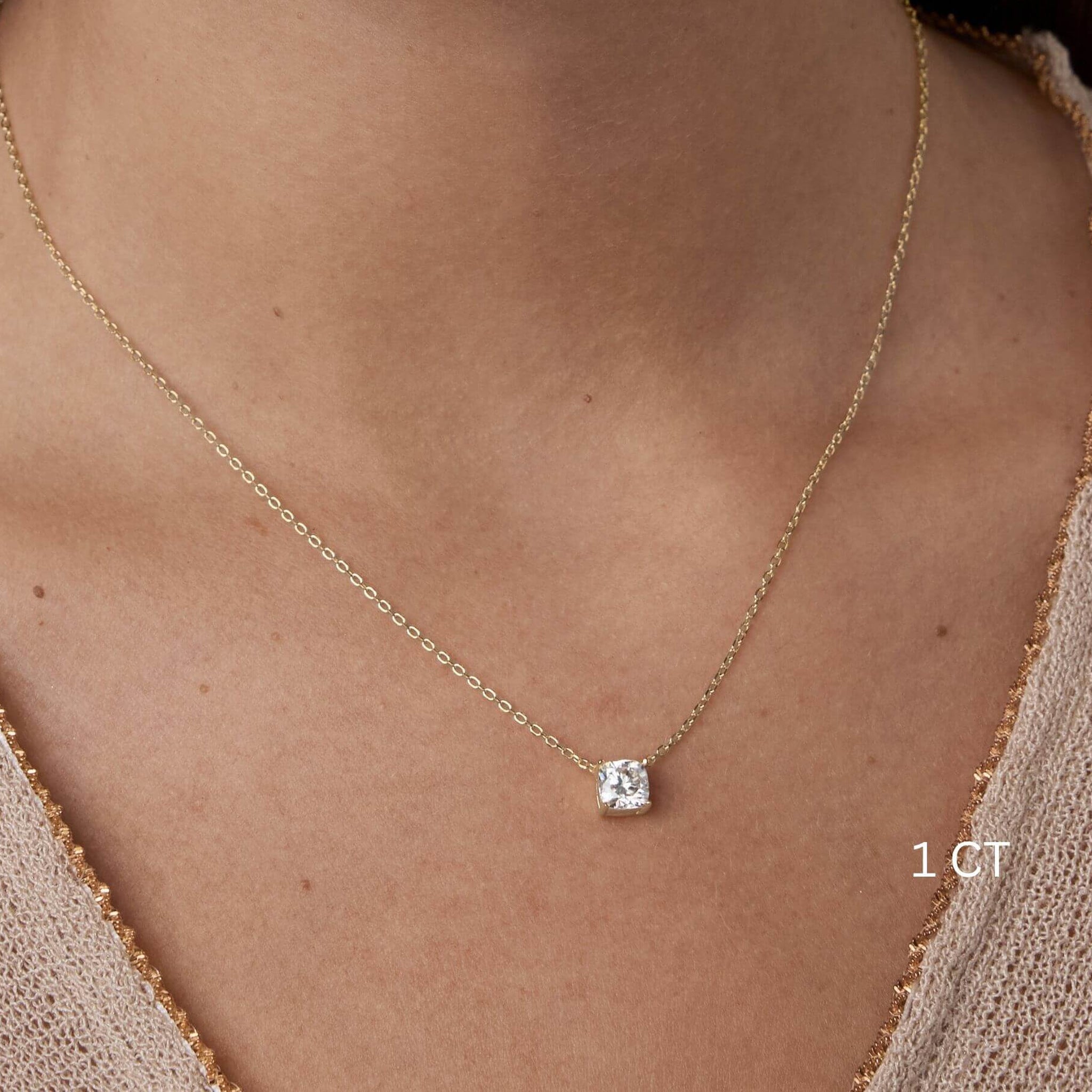 Cushion-cut moissanite pendant necklace worn at the neckline.