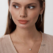 Cushion-cut moissanite pendant necklace worn at the neckline.