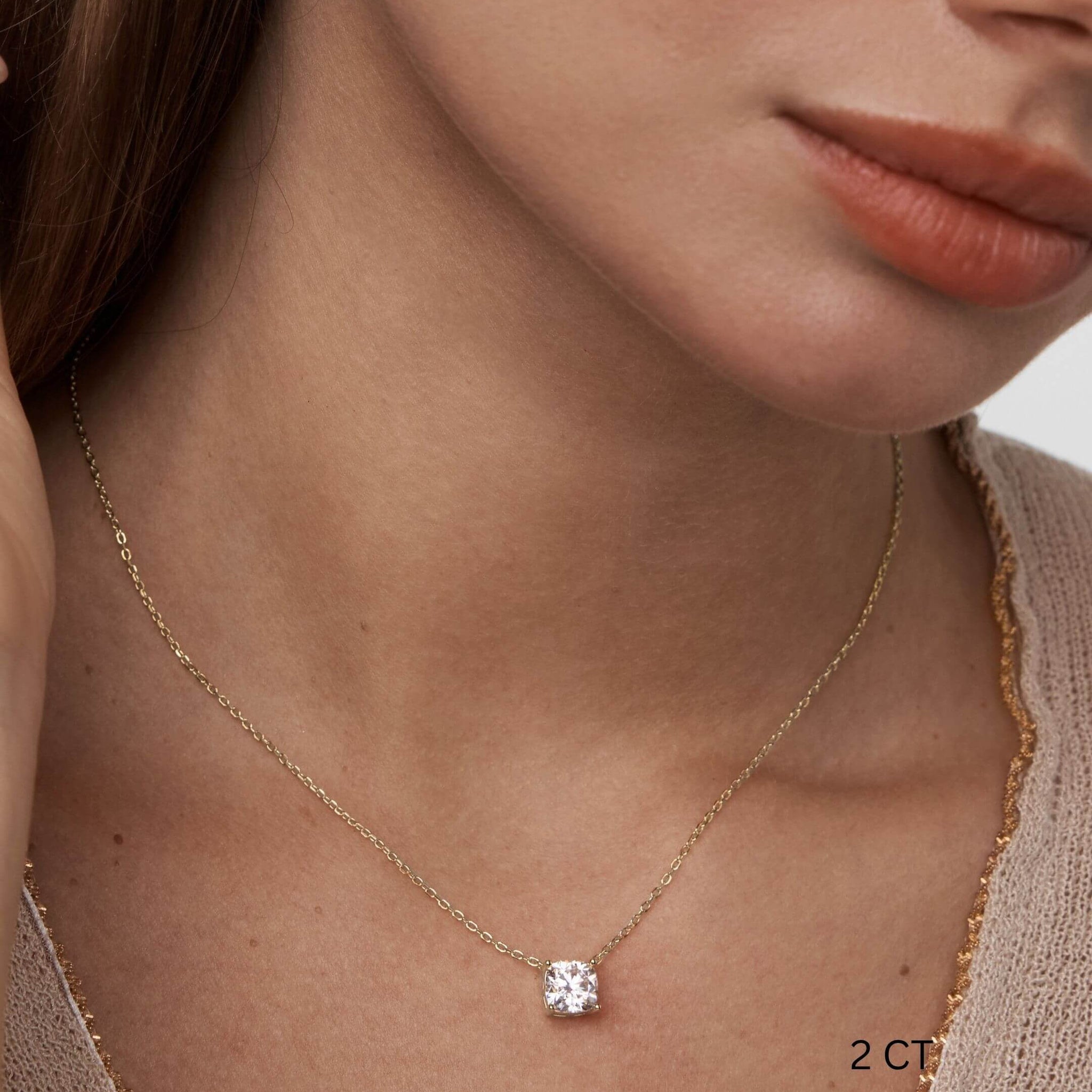 Cushion-cut moissanite pendant necklace worn at the neckline.