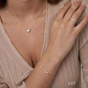 Cushion-cut moissanite pendant necklace worn at the neckline.