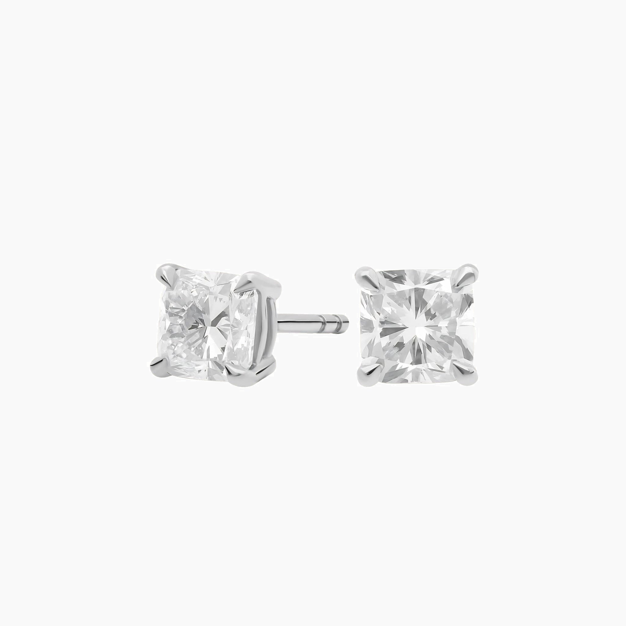 Cushion-cut moissanite stud earrings in white gold vermeil, front and side views.