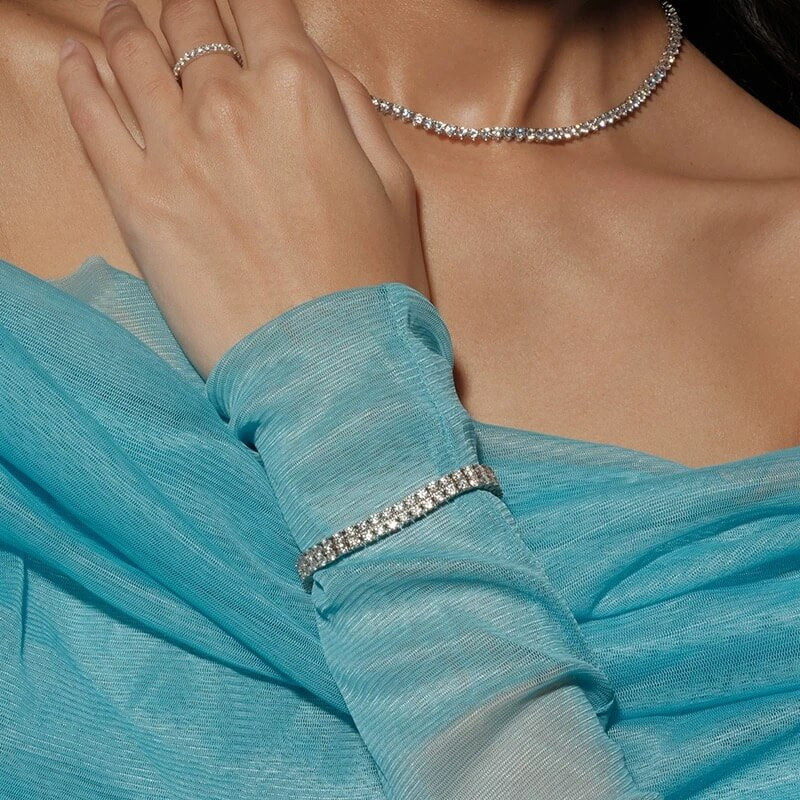 Double-row moissanite tennis bracelet worn on the wrist.