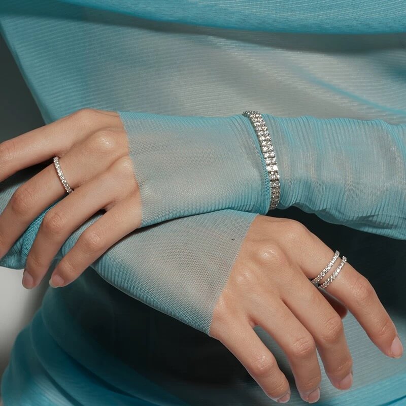 Double-row moissanite tennis bracelet worn on the wrist.