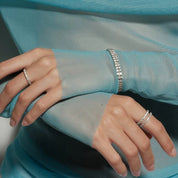 Double-row moissanite tennis bracelet worn on the wrist.