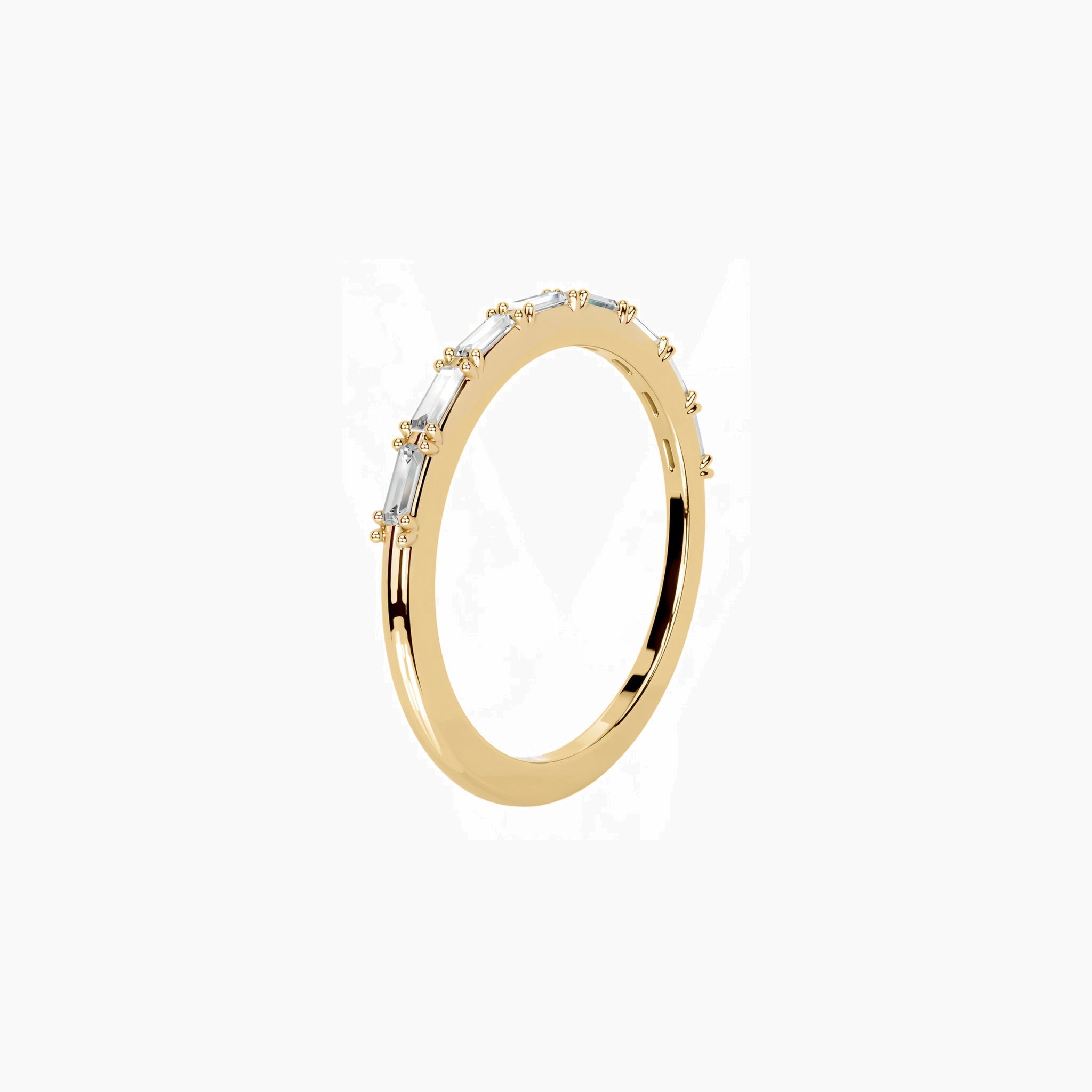 East-west emerald-cut moissanite half eternity ring in yellow gold vermeil, side view.