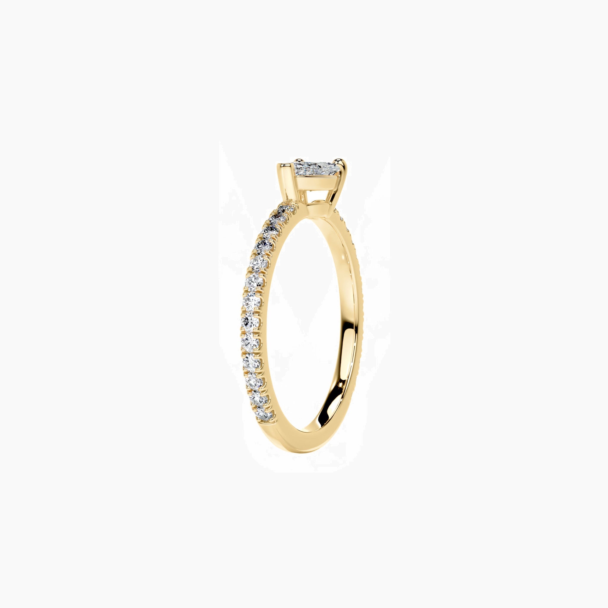 East-west pear-cut moissanite solitaire ring with pavé band in yellow gold vermeil, side view.