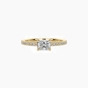 East-west radiant-cut moissanite solitaire ring with pavé band in yellow gold vermeil, front view.