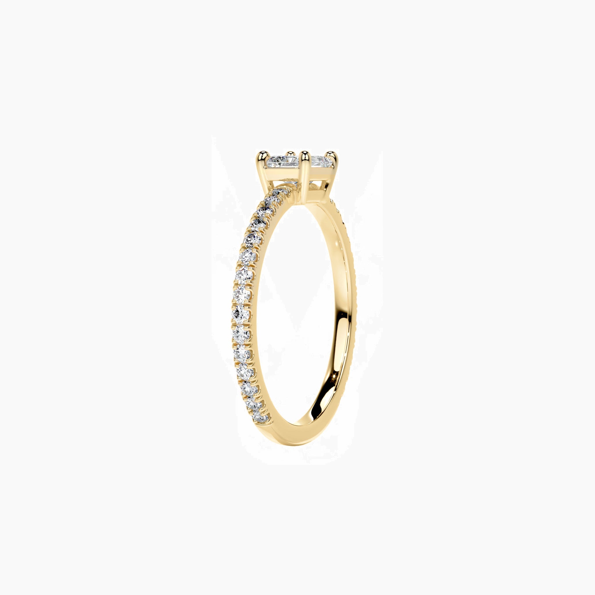 East-west radiant-cut moissanite solitaire ring with pavé band in yellow gold vermeil, side view.