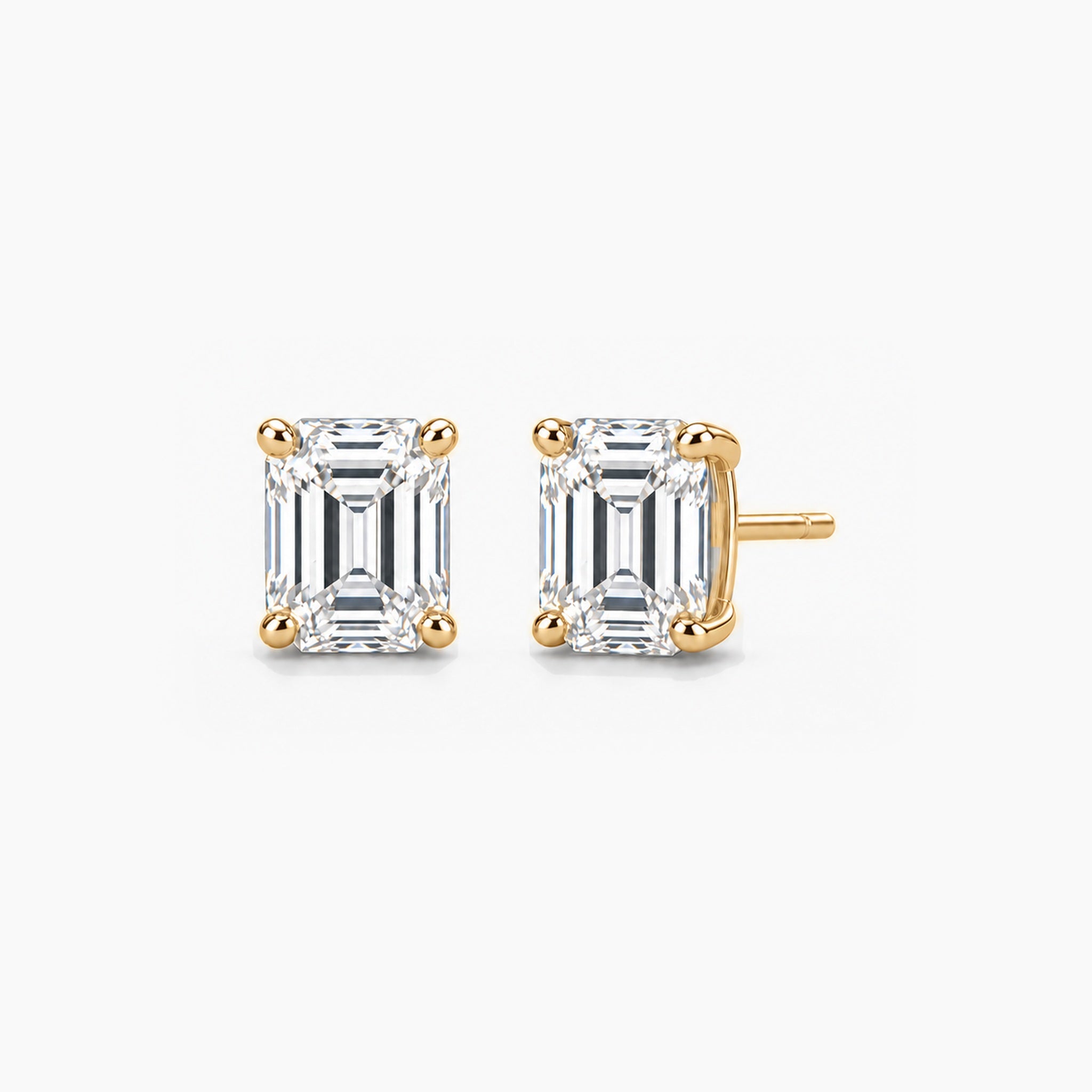 Emerald-cut lab-grown diamond stud earrings in 14k yellow gold, front and three-quarter views.