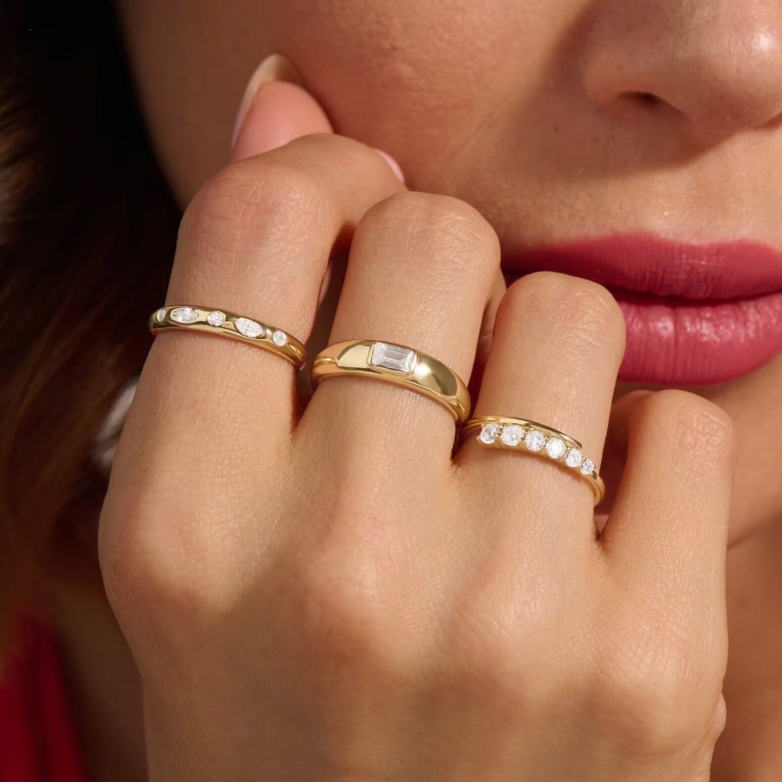 Emerald-cut moissanite bezel dome ring worn on a finger.