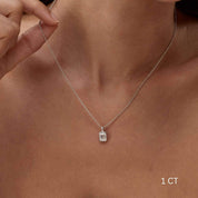 Emerald-cut moissanite bezel pendant necklace worn at the neckline.