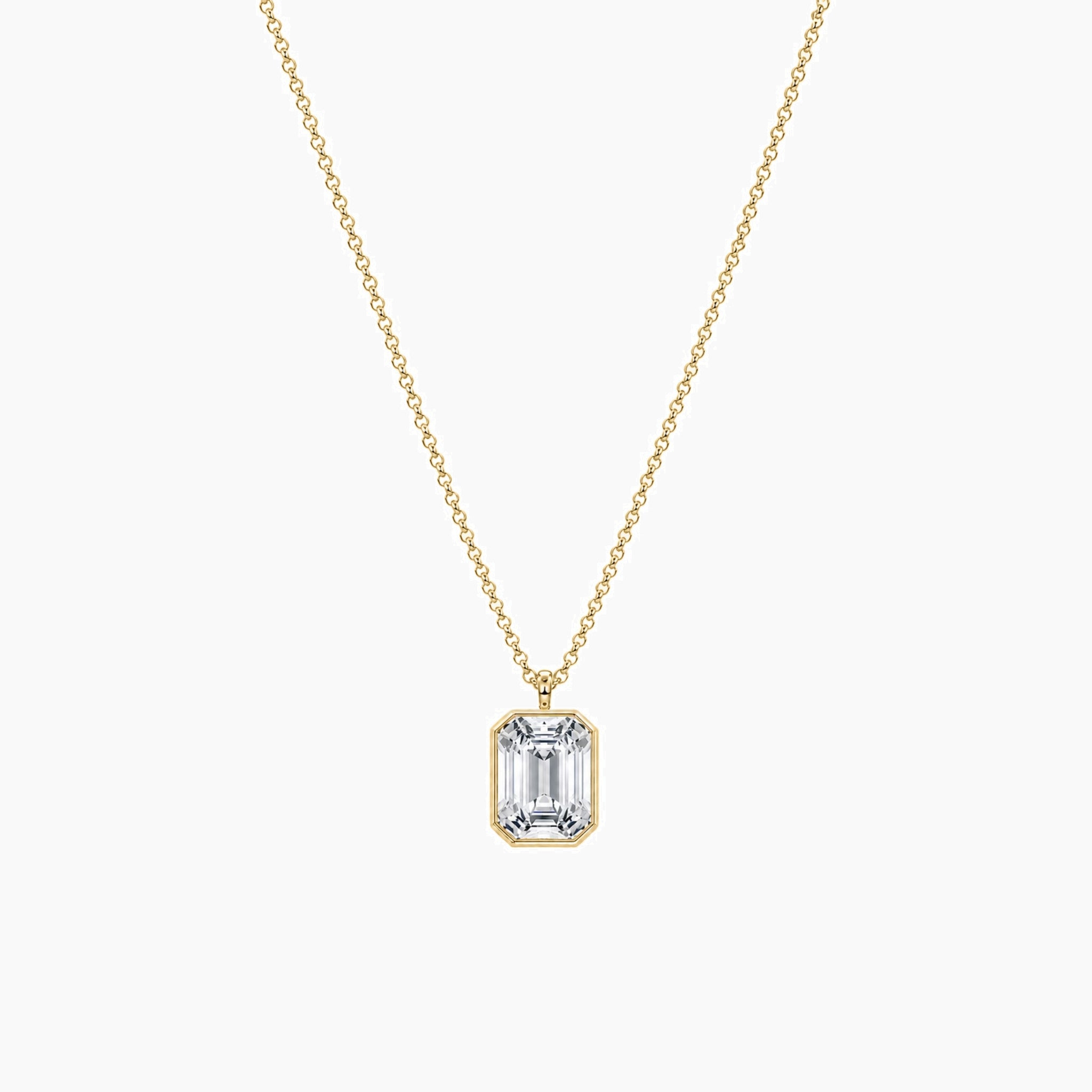 Emerald-cut moissanite bezel pendant necklace in yellow gold vermeil, full product view.