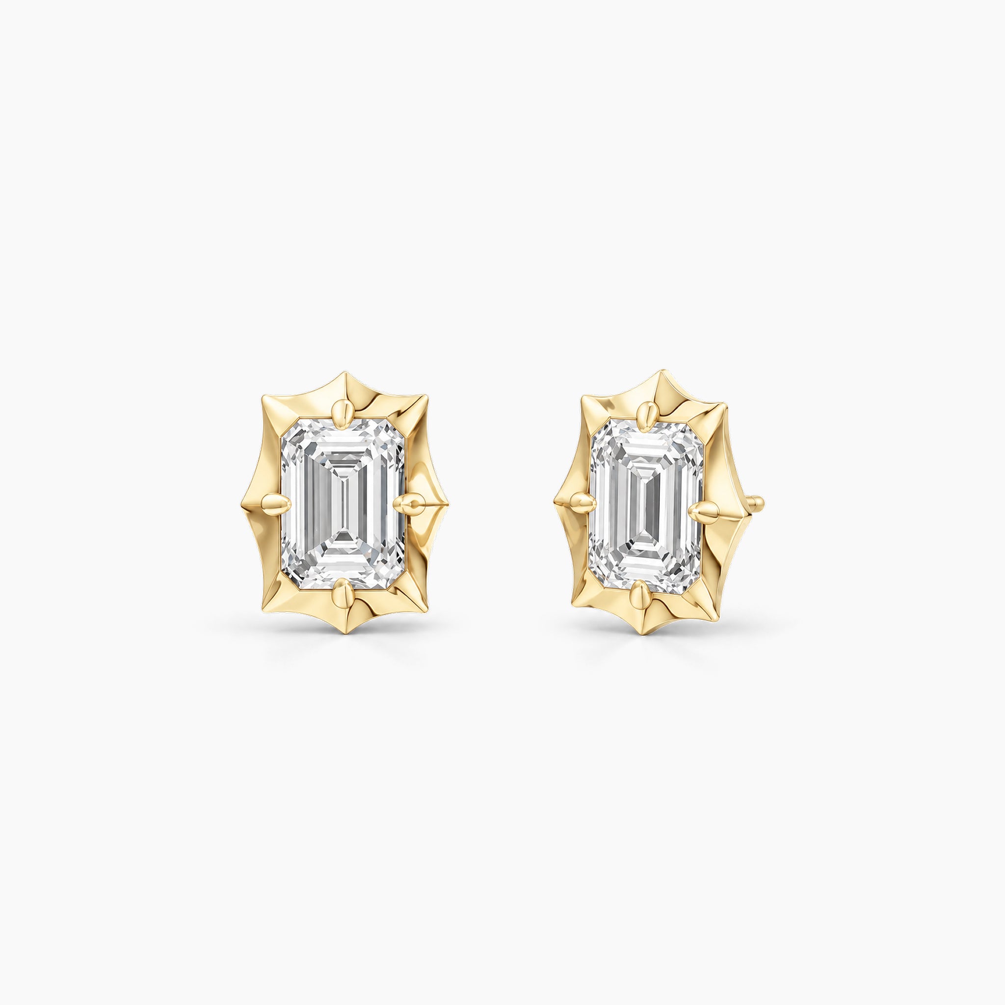 Emerald-cut moissanite bezel-prong stud earrings in 18k yellow gold vermeil, front and angled views.