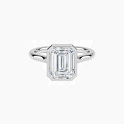 Emerald-cut moissanite bezel solitaire ring in white gold vermeil, front view.
