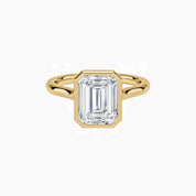 Emerald-cut moissanite bezel solitaire ring in yellow gold vermeil, front view.