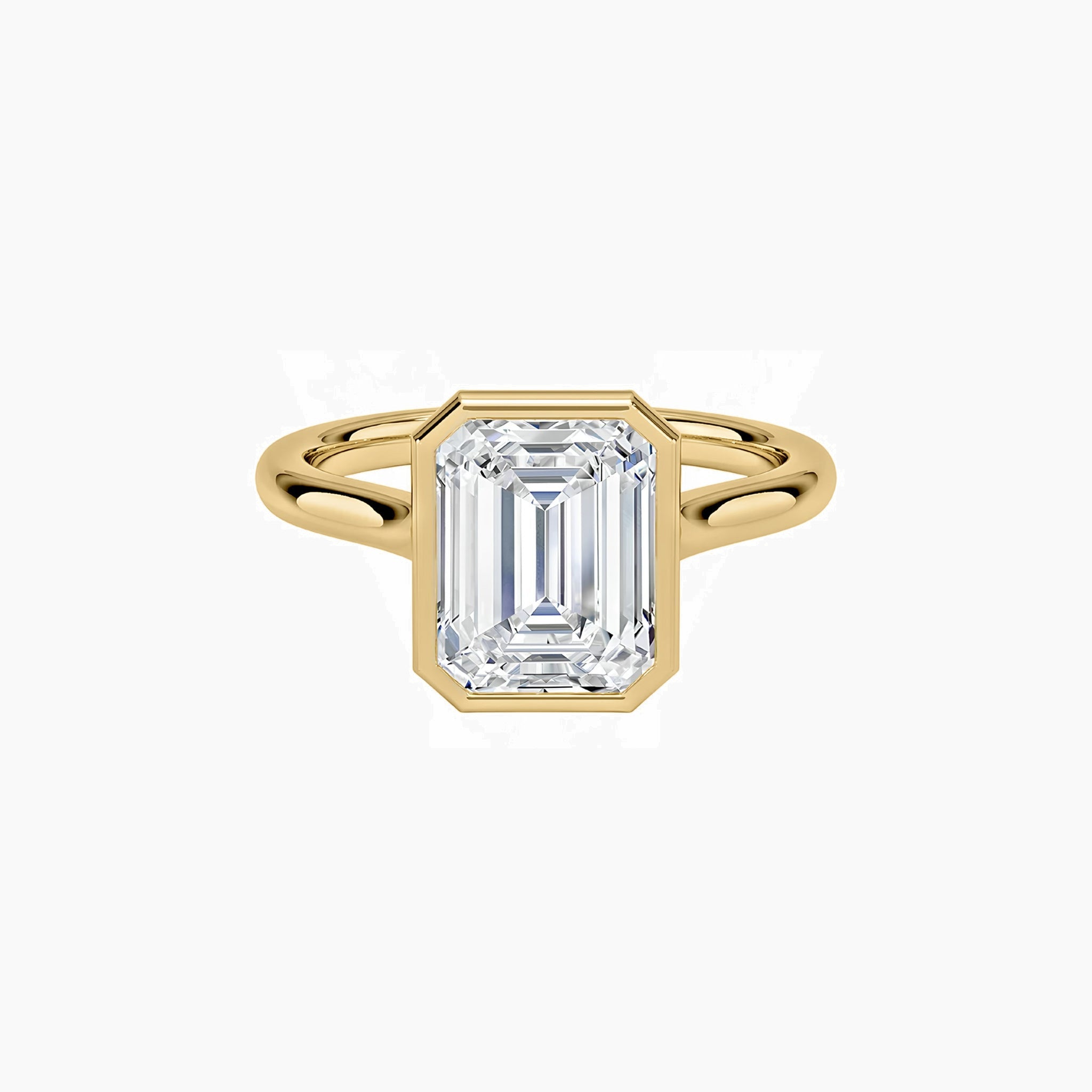 Emerald-cut moissanite bezel solitaire ring in yellow gold vermeil, front view.