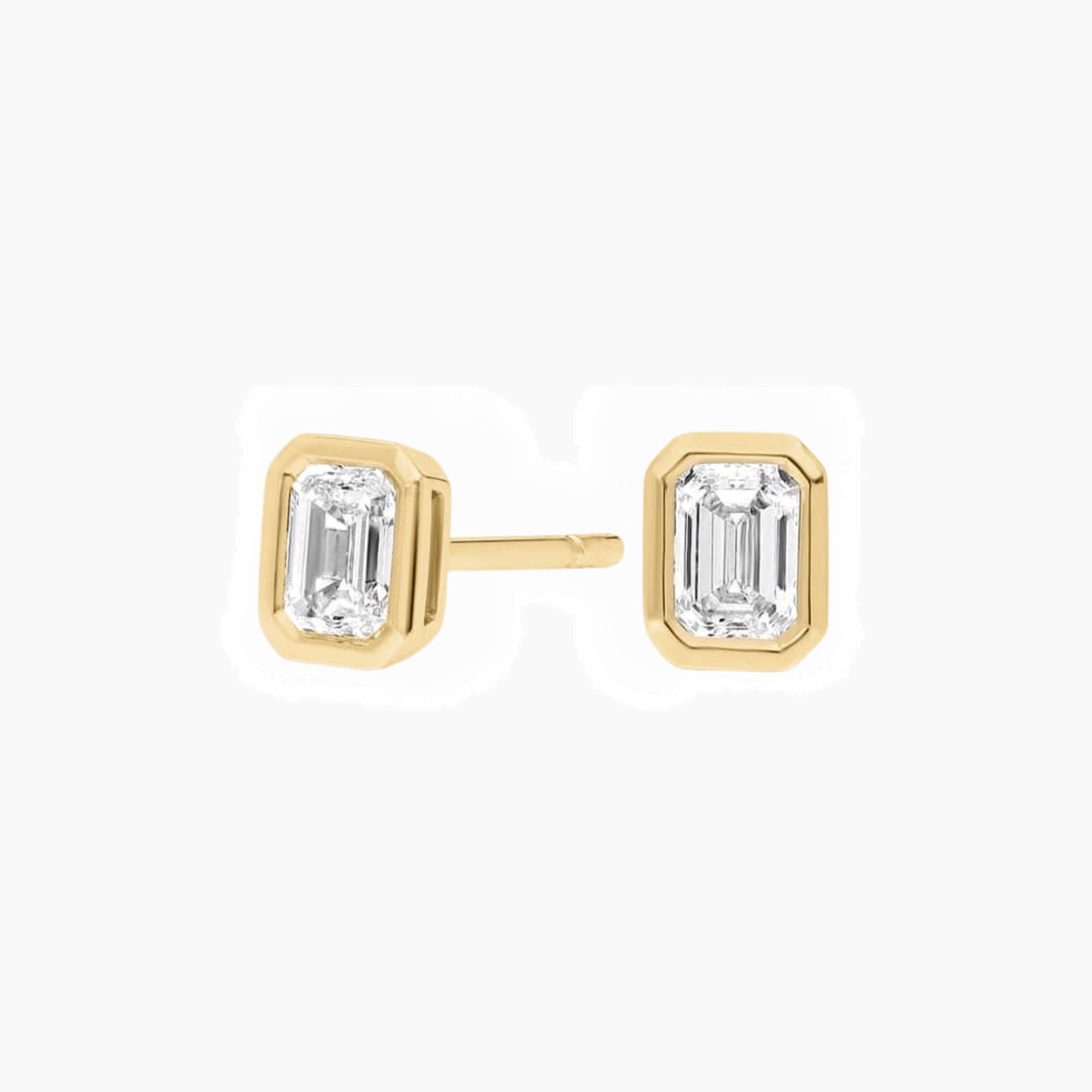 Emerald-cut moissanite bezel stud earrings in yellow gold vermeil, front and side views.