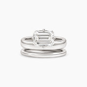 Emerald-cut moissanite double-band solitaire ring in white gold vermeil, front view.