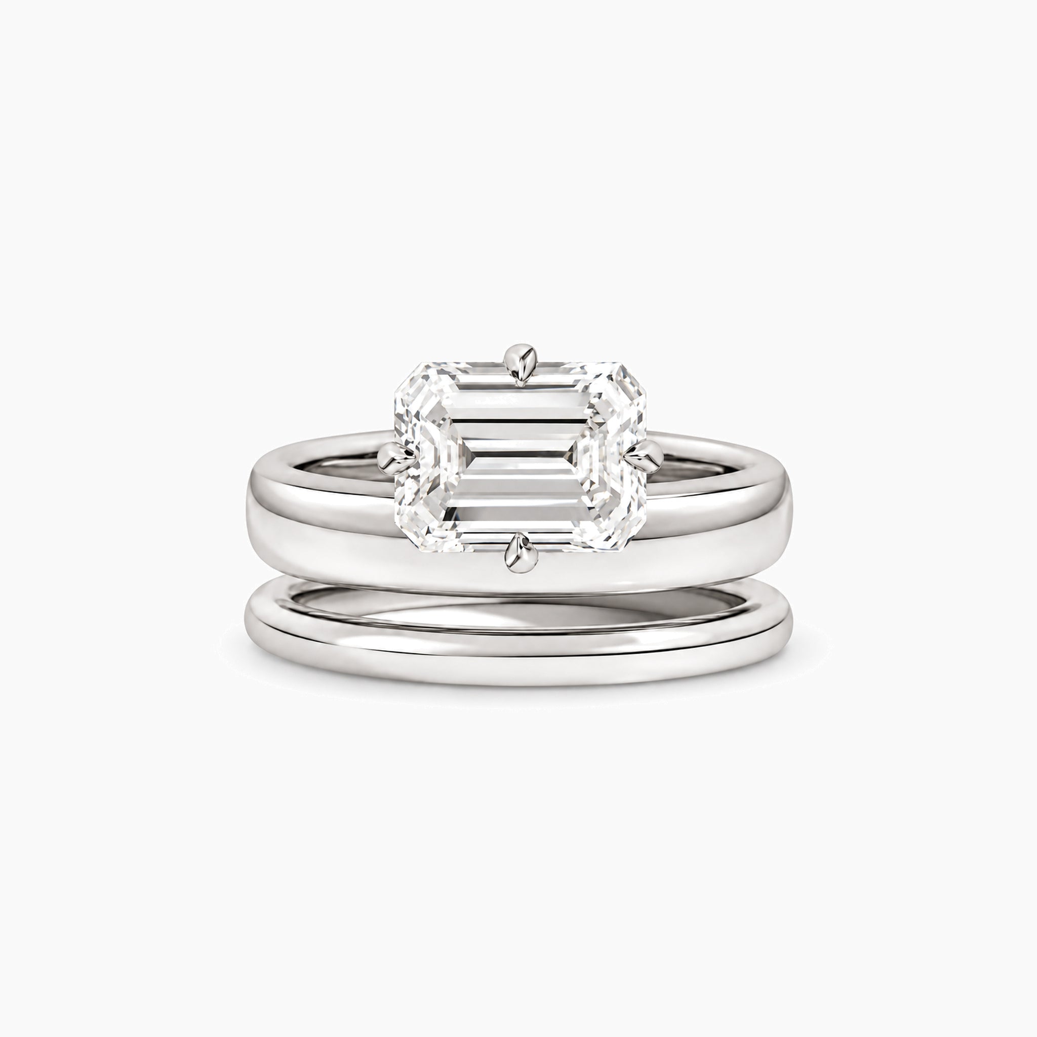 Emerald-cut moissanite double-band solitaire ring in white gold vermeil, front view.