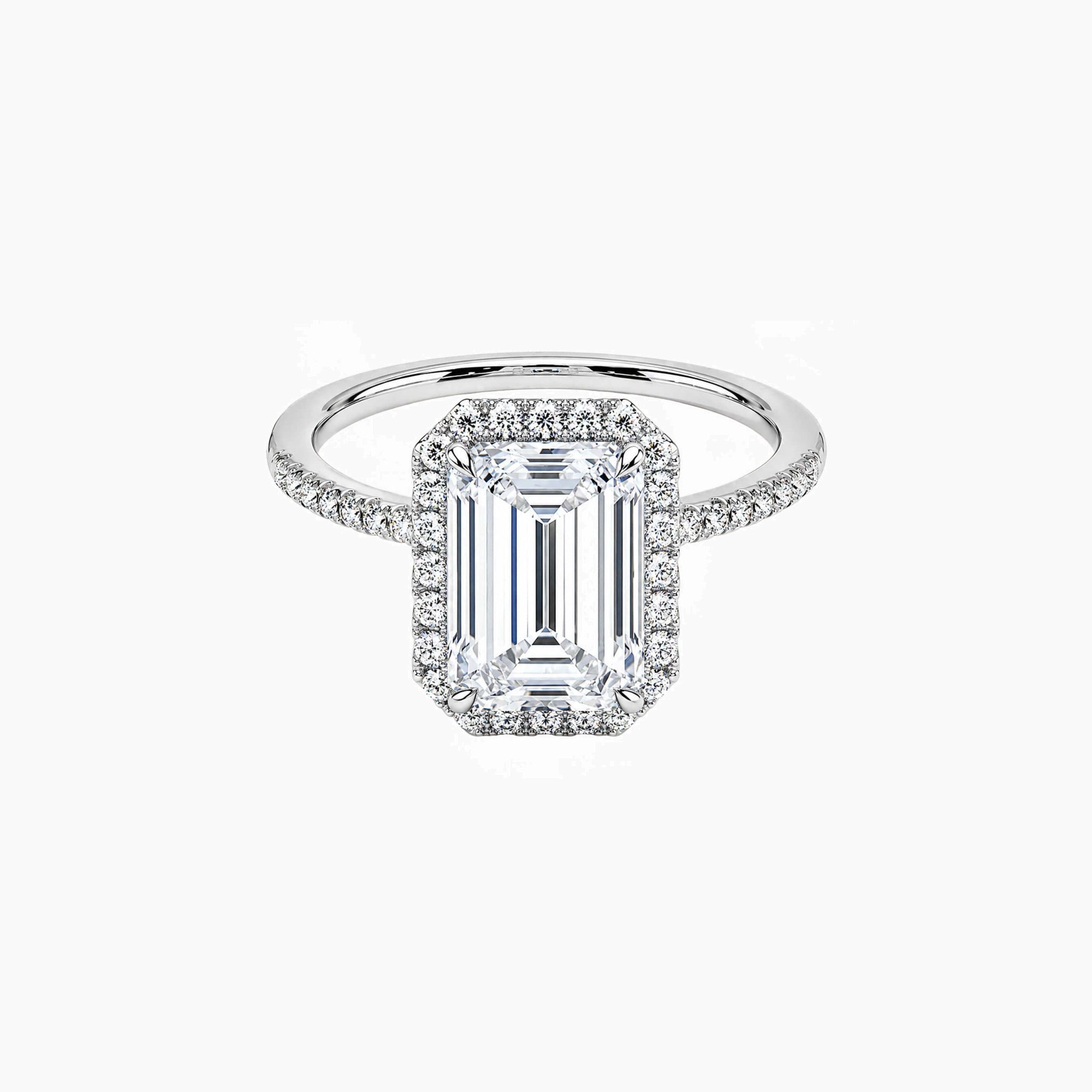Emerald-cut moissanite halo ring with pavé band in white gold vermeil, front view.