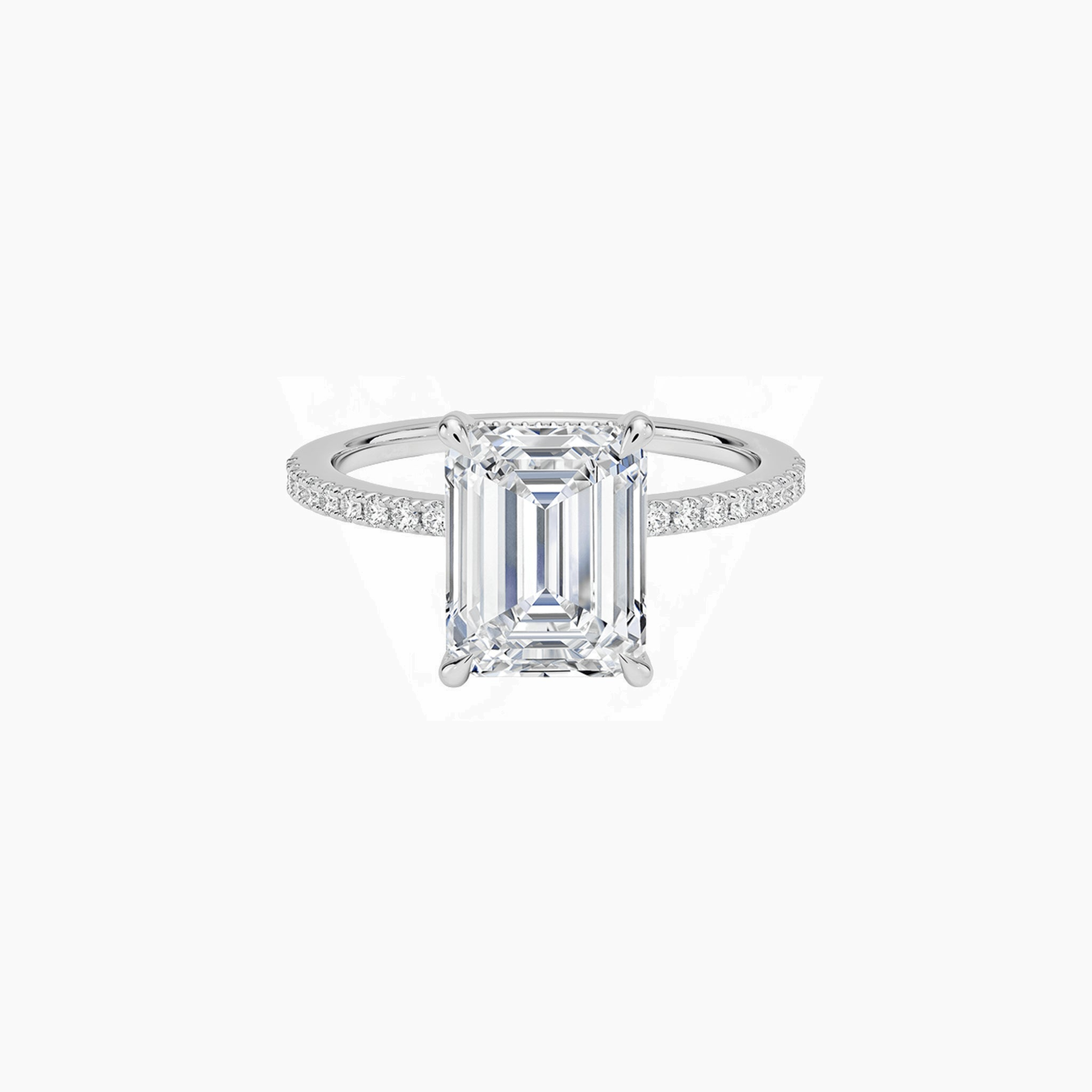 Emerald-cut moissanite hidden halo ring with pavé band in white gold vermeil, front view.
