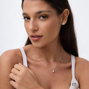 Emerald-cut moissanite pendant necklace worn at the neckline.