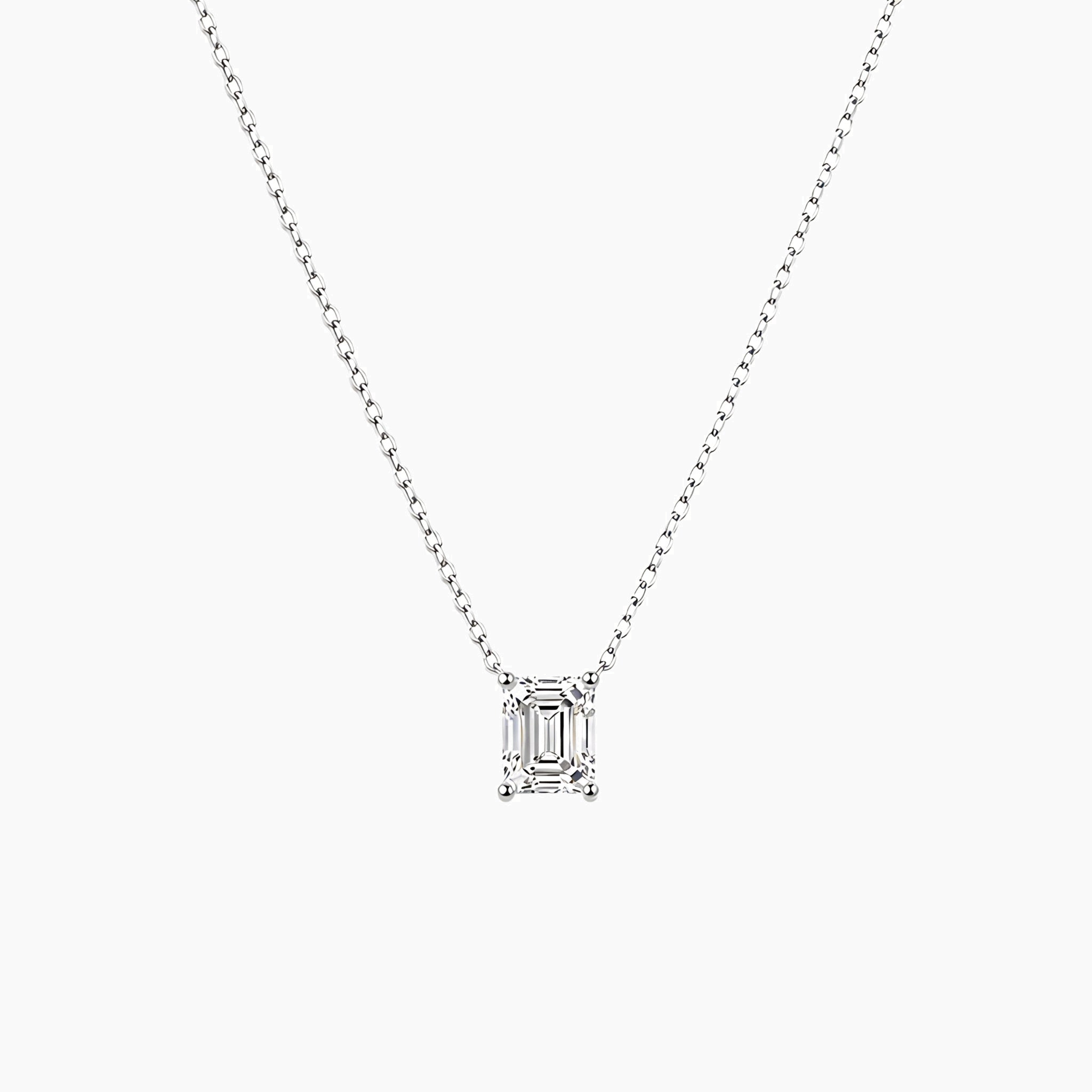 Emerald-cut moissanite pendant necklace in white gold vermeil, front view.