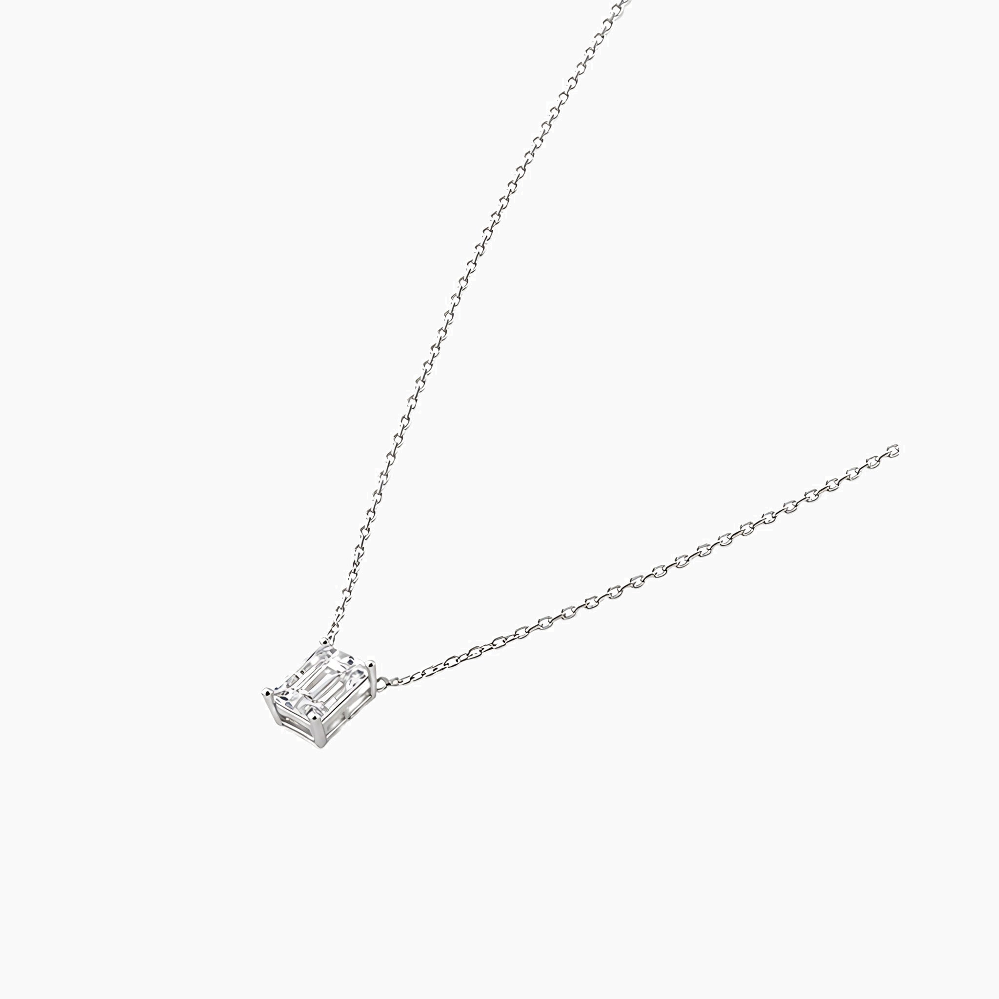 Emerald-cut moissanite pendant necklace in white gold vermeil, side view.
