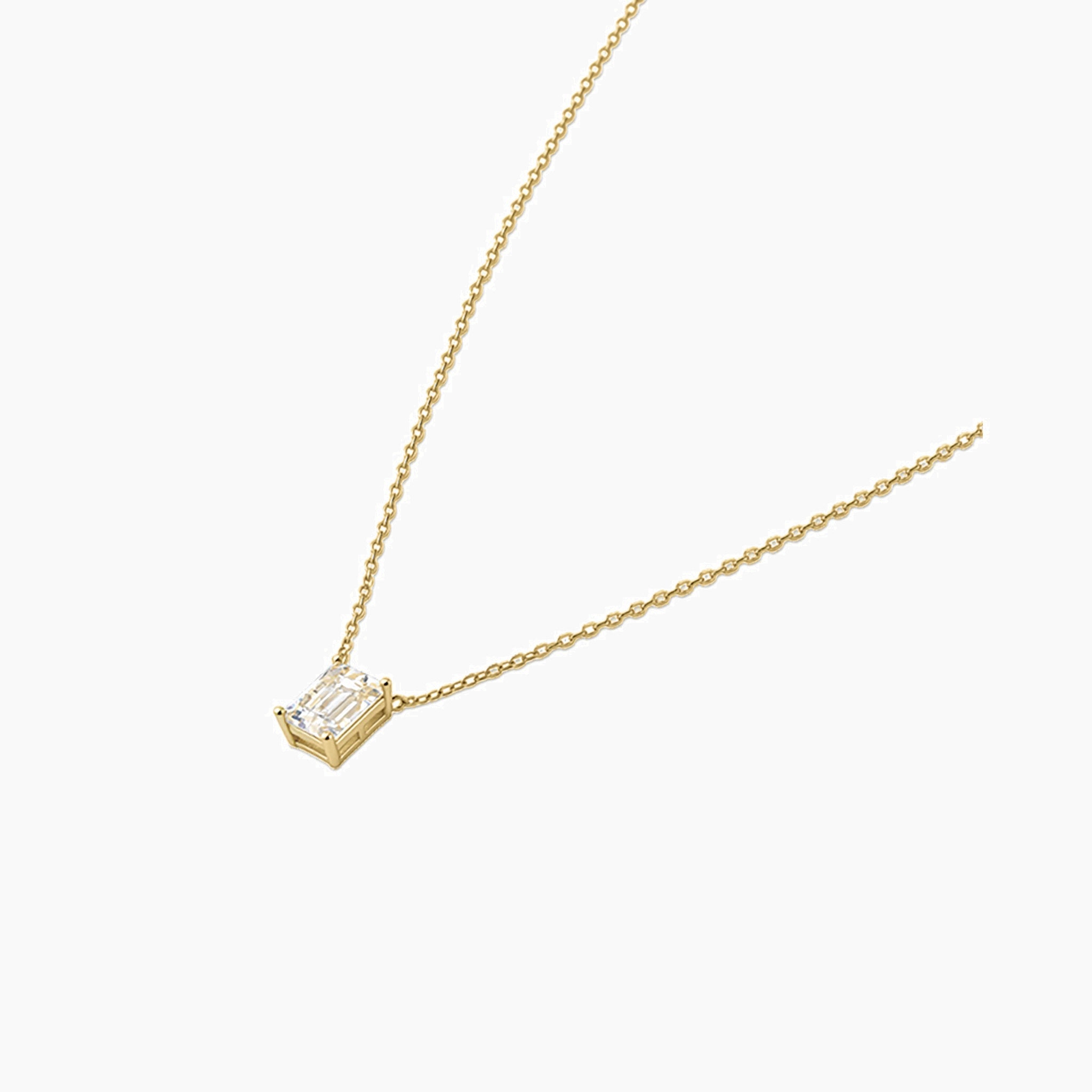 Emerald-cut moissanite pendant necklace in yellow gold vermeil, side view.