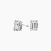 Emerald-cut moissanite stud earrings in white gold vermeil, front and side views.