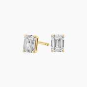 Emerald-cut moissanite stud earrings in yellow gold vermeil, front and side views.