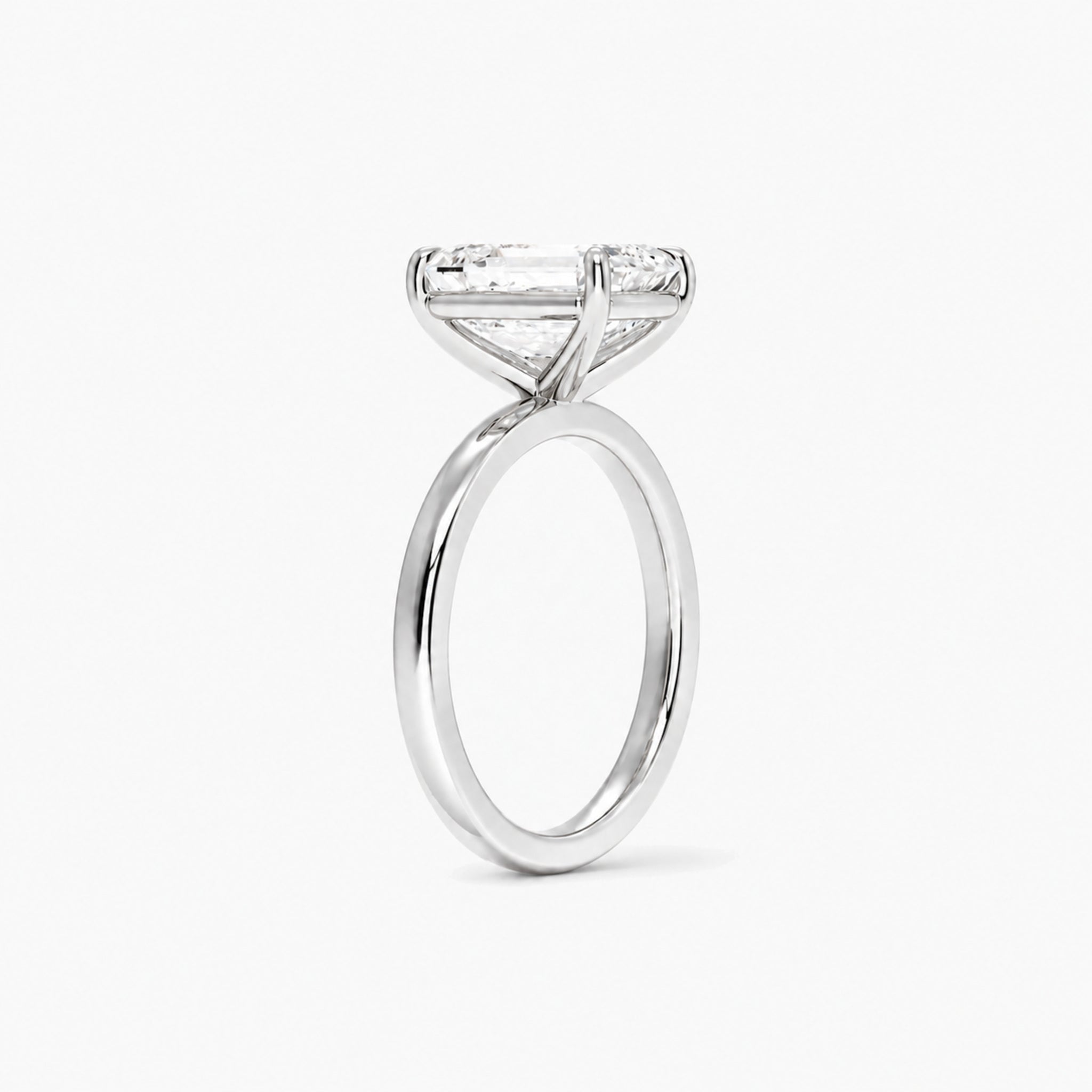 Emerald-cut moissanite solitaire ring in white gold vermeil, side view