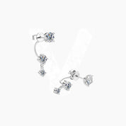 Floating three-stone moissanite drop earrings in white gold vermeil, angled view.
