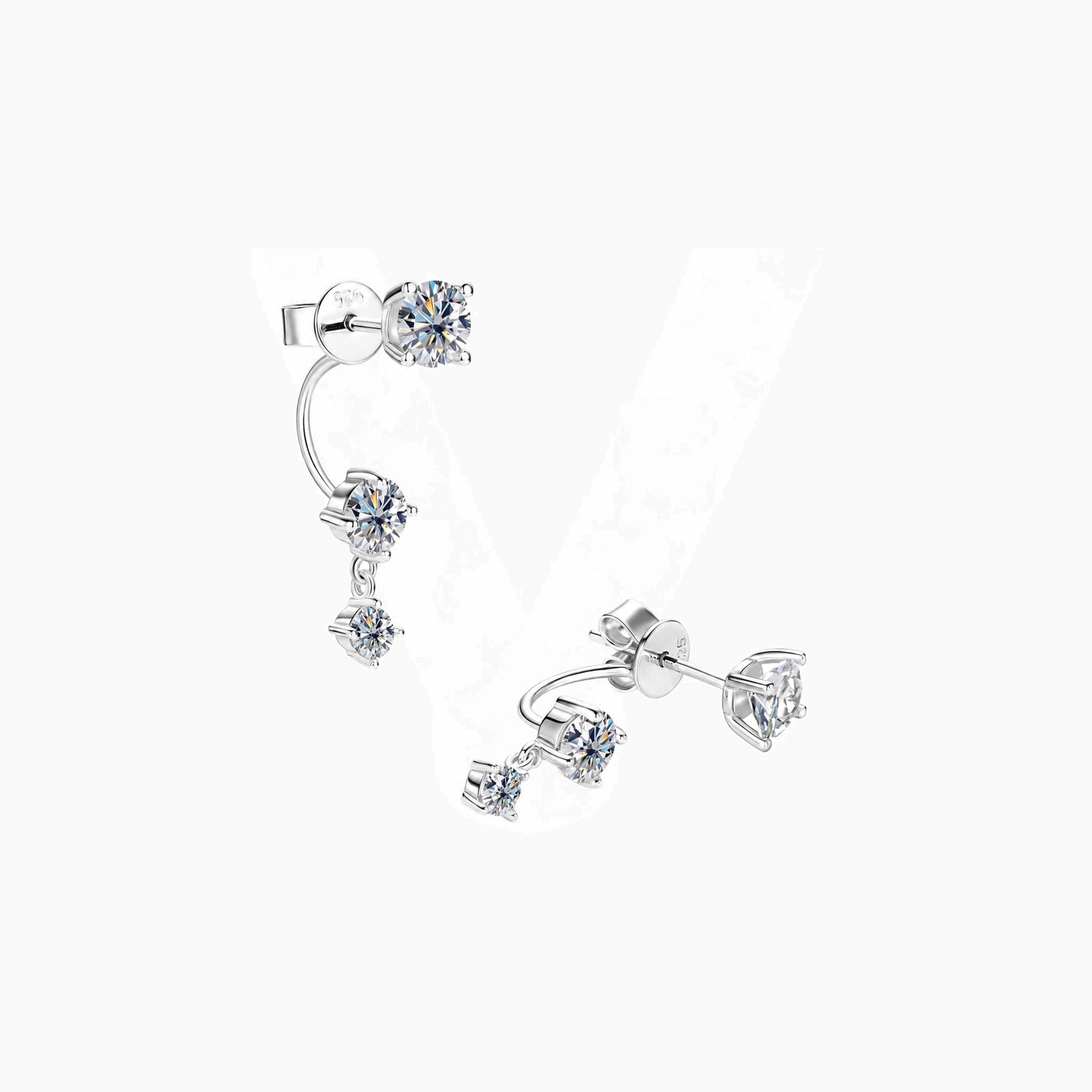 Floating three-stone moissanite drop earrings in white gold vermeil, angled view.